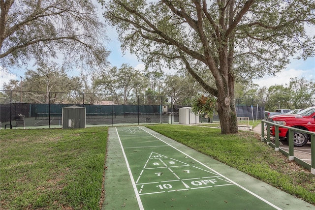 view of property's community with a storage unit and a yard