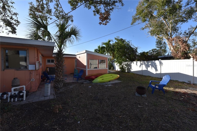 view of yard with cooling unit and fence