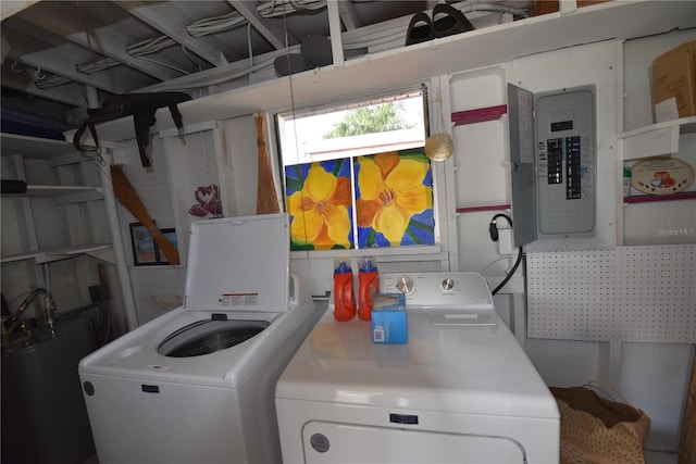 washroom featuring laundry area, electric panel, and washing machine and clothes dryer