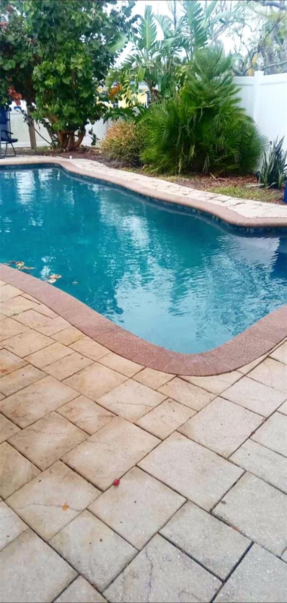 view of swimming pool with fence