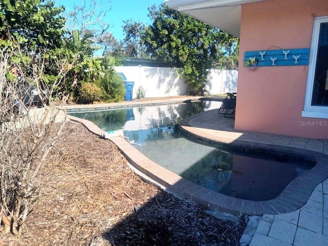 view of swimming pool featuring a fenced backyard and a fenced in pool