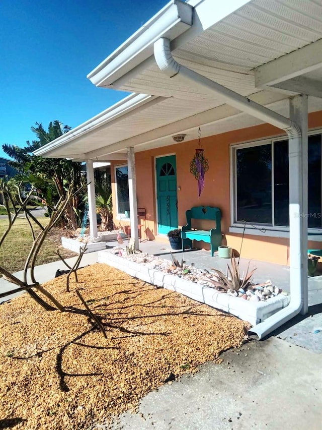 property entrance with stucco siding