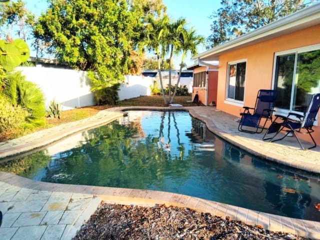 view of pool featuring a fenced backyard, a fenced in pool, and a patio