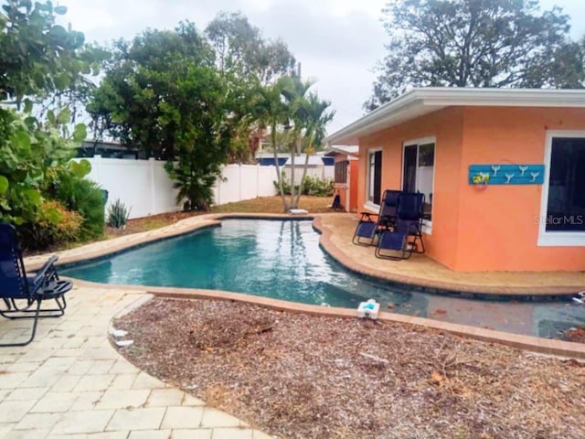 view of swimming pool with a patio, a fenced backyard, and a fenced in pool