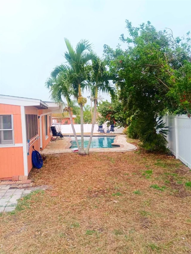 view of yard with a patio, a fenced backyard, and a fenced in pool