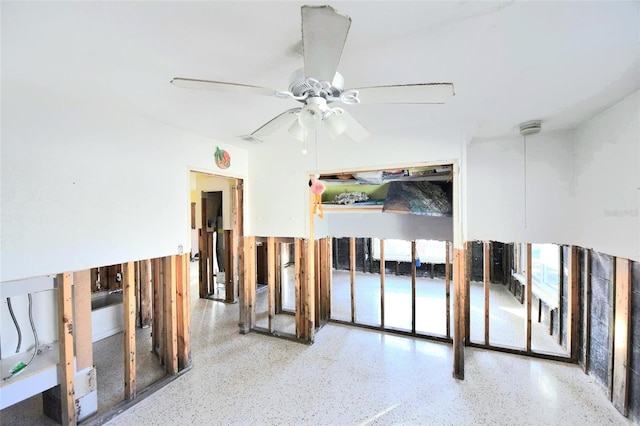 unfurnished room featuring ceiling fan and light speckled floor