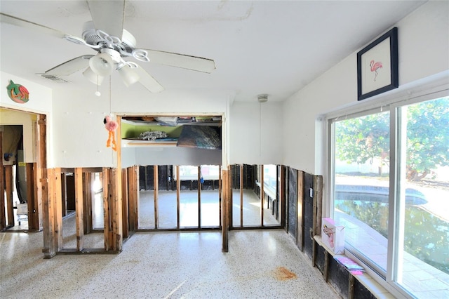 spare room with ceiling fan, speckled floor, and visible vents