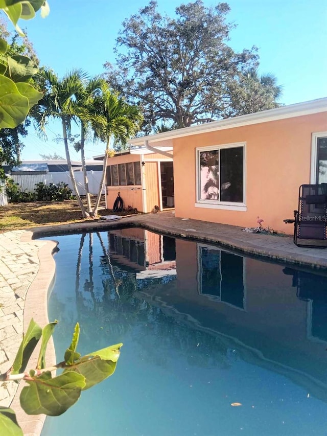 view of swimming pool with fence, a fenced in pool, and a patio