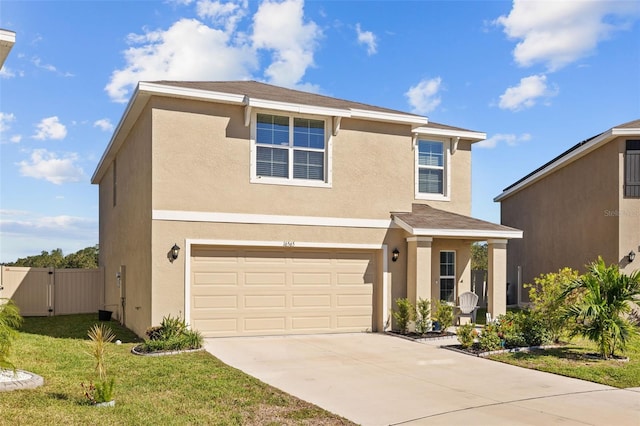 front facade featuring a front yard and a garage