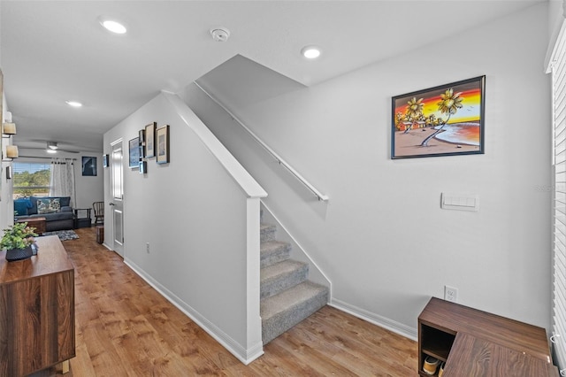 stairway featuring hardwood / wood-style floors and ceiling fan