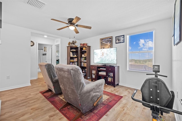 living room featuring ceiling fan and light hardwood / wood-style floors