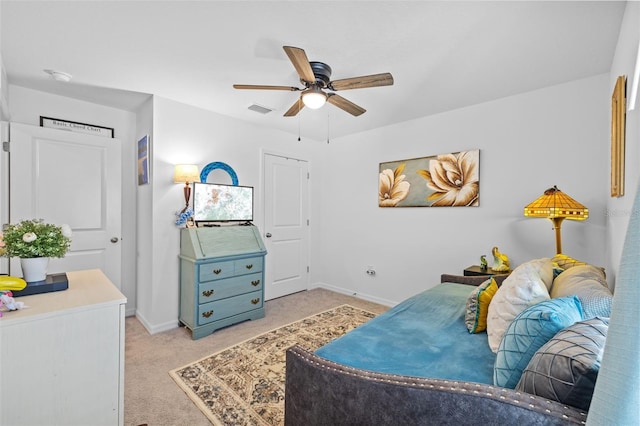 living area featuring ceiling fan and light carpet