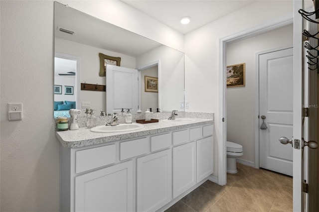 bathroom with tile patterned floors, vanity, and toilet