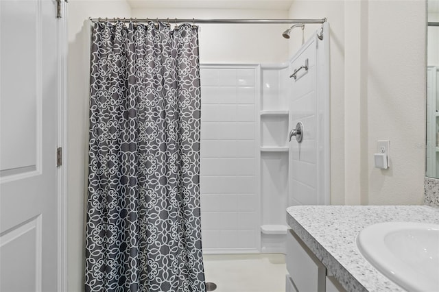 bathroom with a shower with curtain and vanity