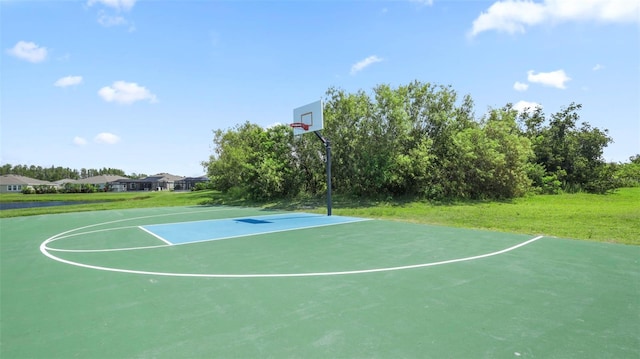 view of basketball court featuring a lawn