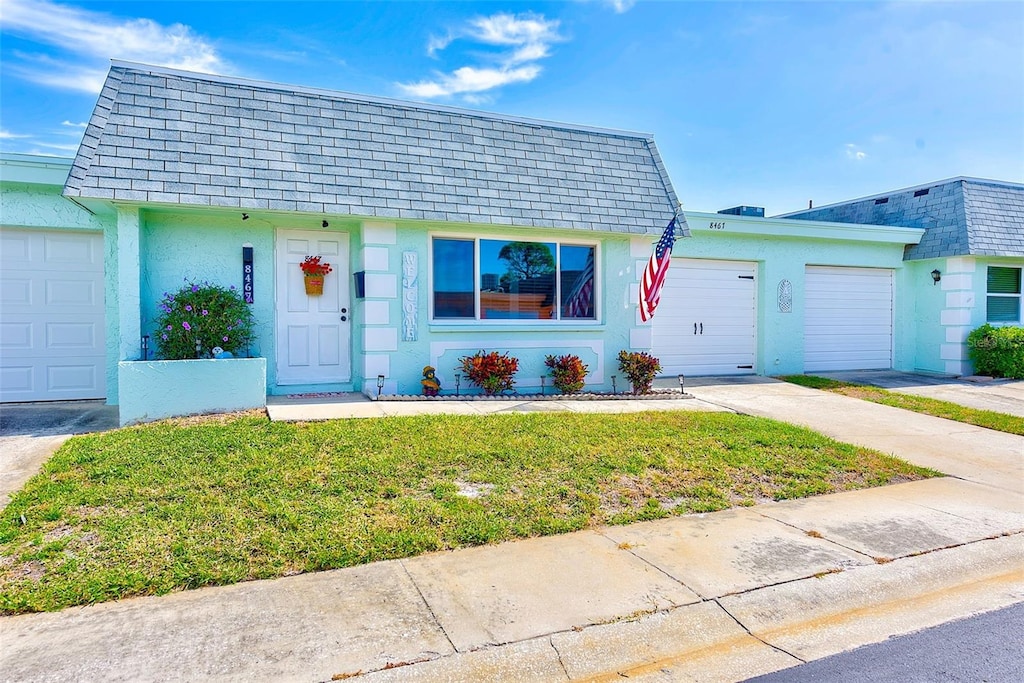 view of front of home featuring a garage and a front yard