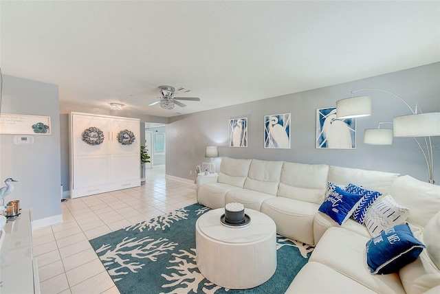 living room with ceiling fan and light tile patterned floors