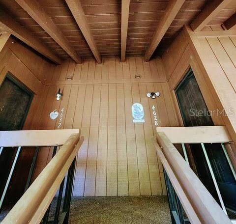 interior space with wood walls and wooden ceiling