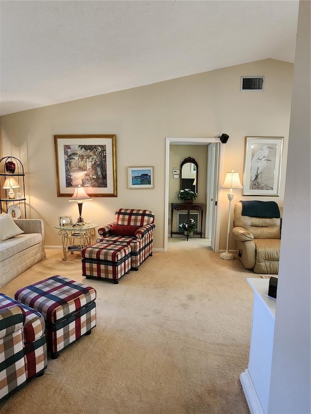 carpeted living room with lofted ceiling