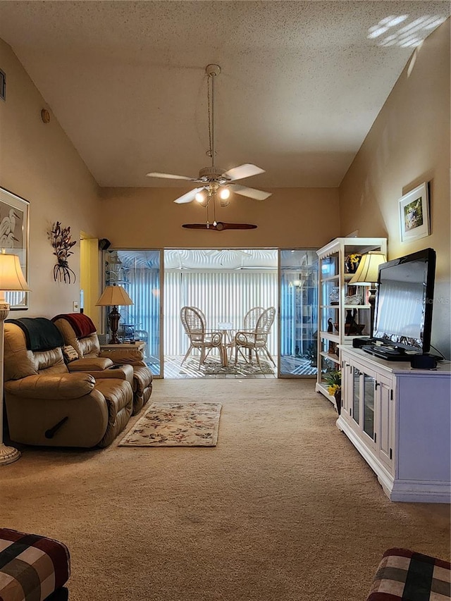 carpeted living room featuring ceiling fan and a textured ceiling