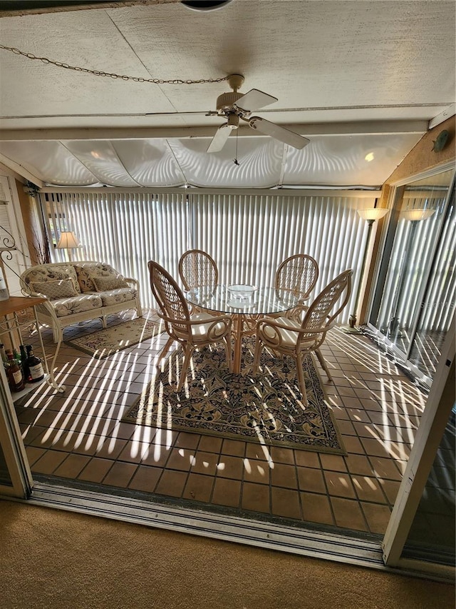 unfurnished sunroom featuring ceiling fan and lofted ceiling