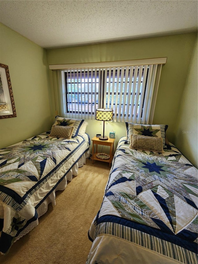 carpeted bedroom featuring a textured ceiling