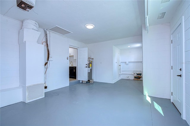 garage featuring a garage door opener and water heater