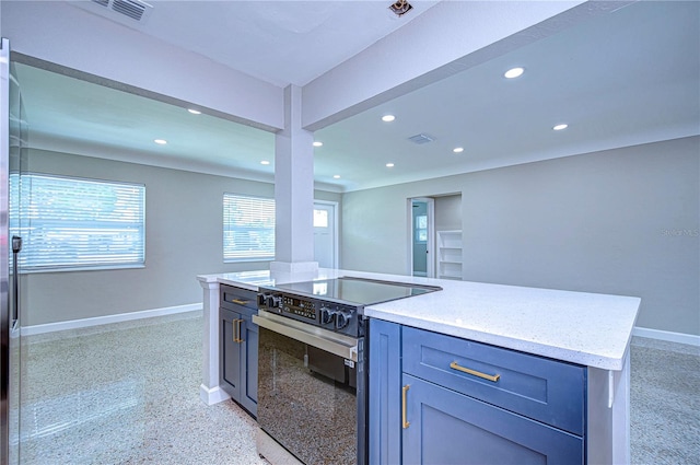 kitchen featuring a center island, range with electric stovetop, and light stone countertops