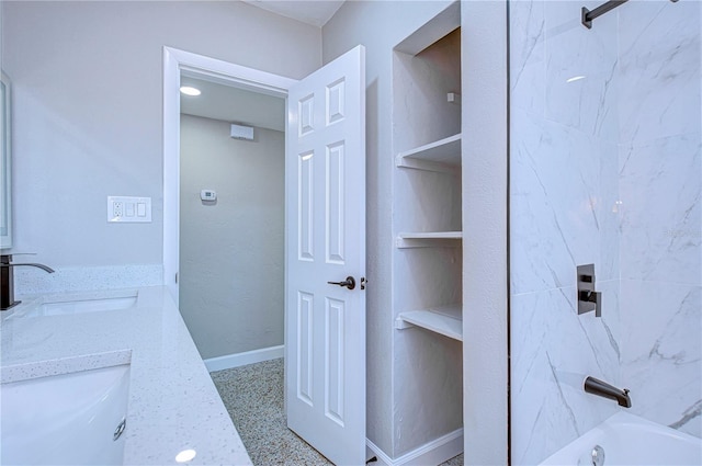 bathroom featuring vanity and tiled shower / bath combo