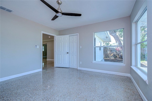 interior space with a wealth of natural light and ceiling fan