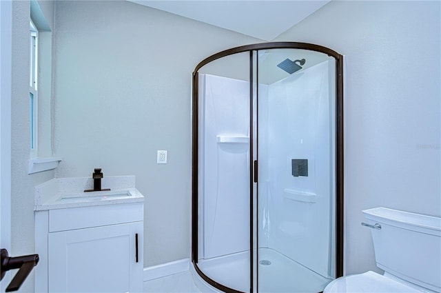 bathroom with tile patterned floors, vanity, toilet, and walk in shower