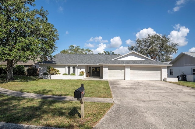 single story home with a garage and a front lawn