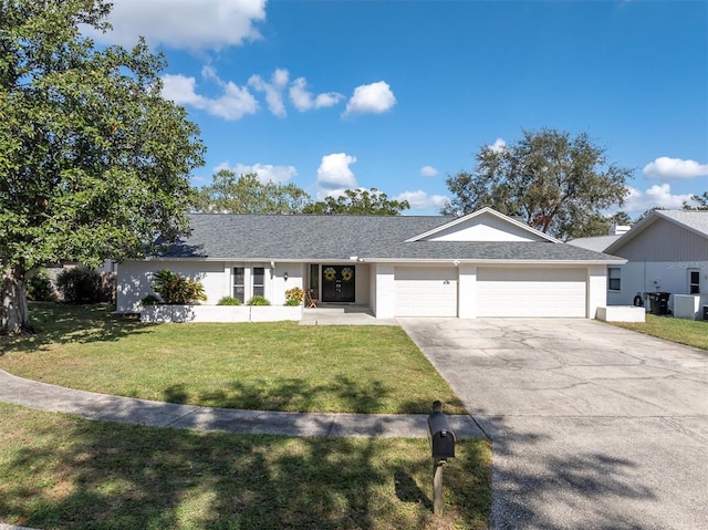 single story home with a garage and a front lawn