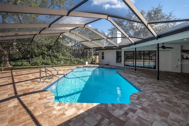 view of pool featuring ceiling fan, a patio area, and glass enclosure