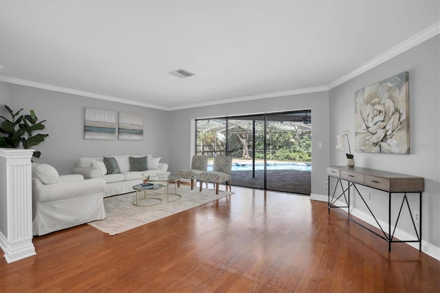 living room with wood-type flooring and crown molding