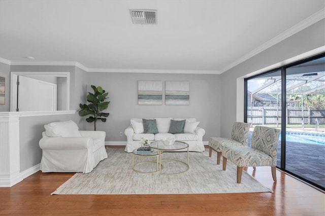 living room featuring hardwood / wood-style flooring and ornamental molding