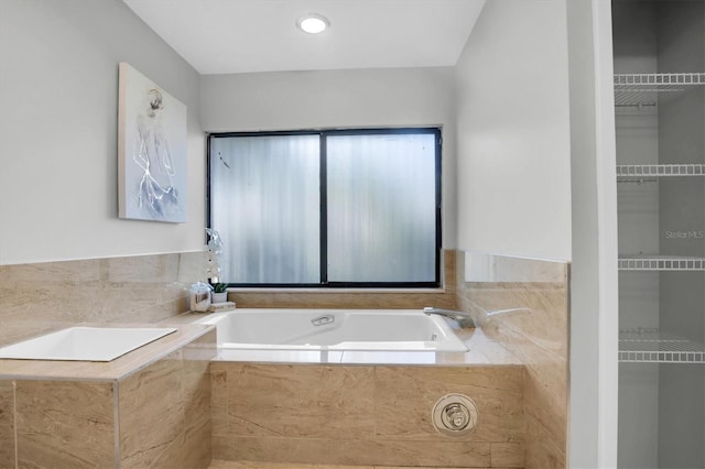 bathroom featuring a relaxing tiled tub