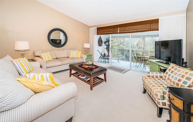 living room featuring lofted ceiling and light carpet