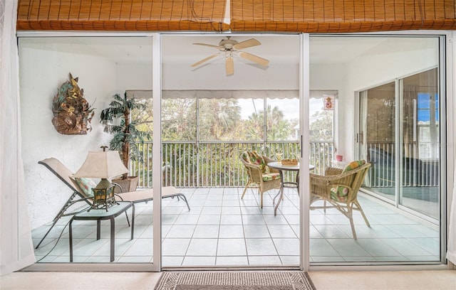 sunroom / solarium featuring ceiling fan