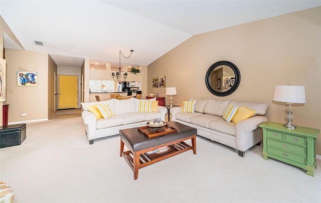 carpeted living room featuring an inviting chandelier and lofted ceiling