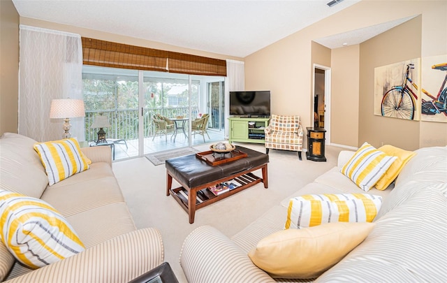 living room featuring lofted ceiling and light carpet