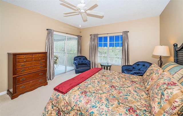 carpeted bedroom with ceiling fan, a textured ceiling, access to outside, and multiple windows