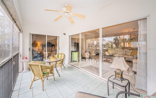 sunroom / solarium featuring a wealth of natural light and ceiling fan