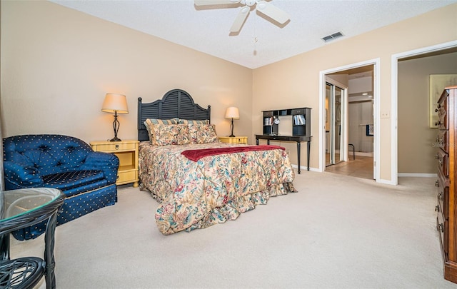 bedroom with carpet, ceiling fan, ensuite bathroom, and a textured ceiling