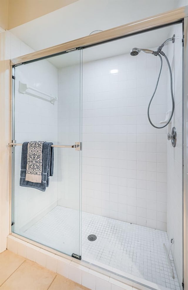 bathroom featuring tile patterned floors and a shower with shower door