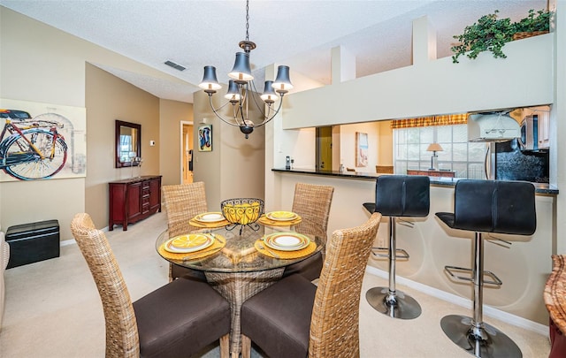 carpeted dining space featuring a textured ceiling, a chandelier, and vaulted ceiling