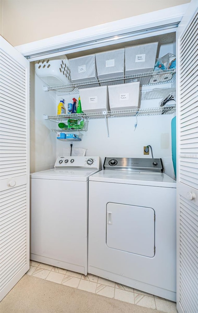 clothes washing area with washer and dryer