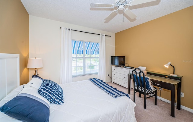 carpeted bedroom featuring ceiling fan and a textured ceiling