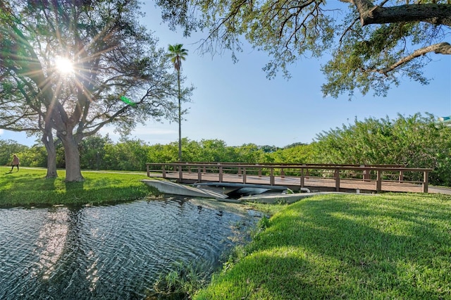 dock area featuring a lawn and a water view