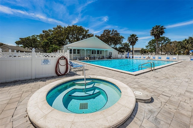 view of swimming pool with a community hot tub and a patio